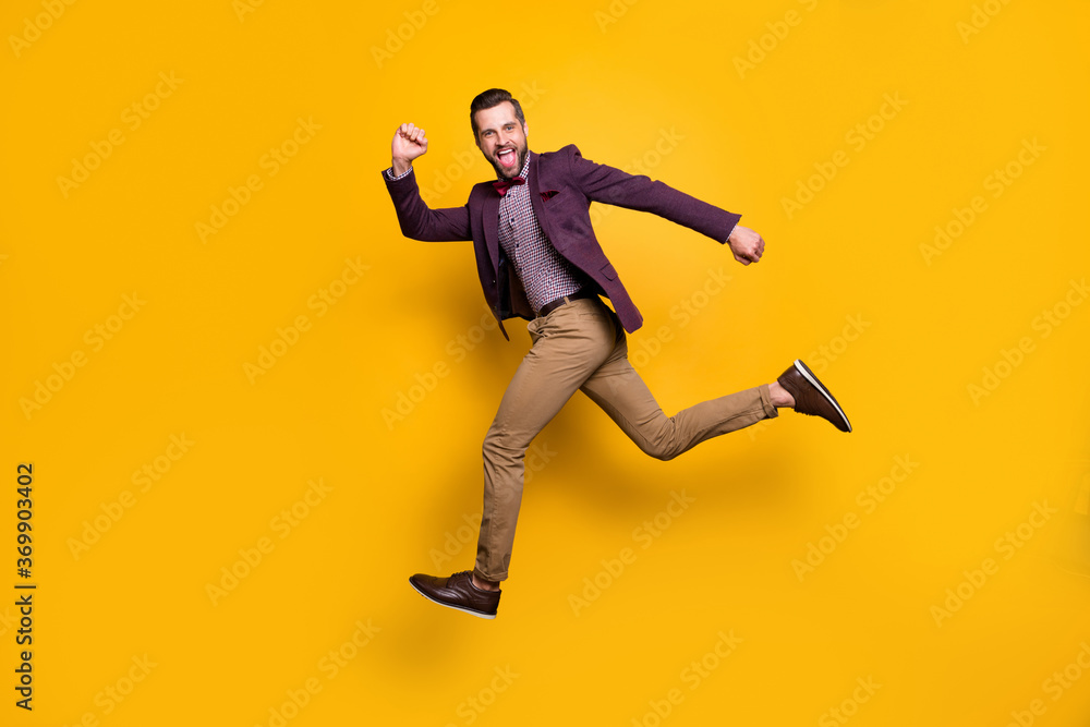 Full length profile photo of handsome rich clothes stylish guy well-dressed jumping high up rushing store mall sales wear plaid shirt blazer trousers shoes isolated yellow color background