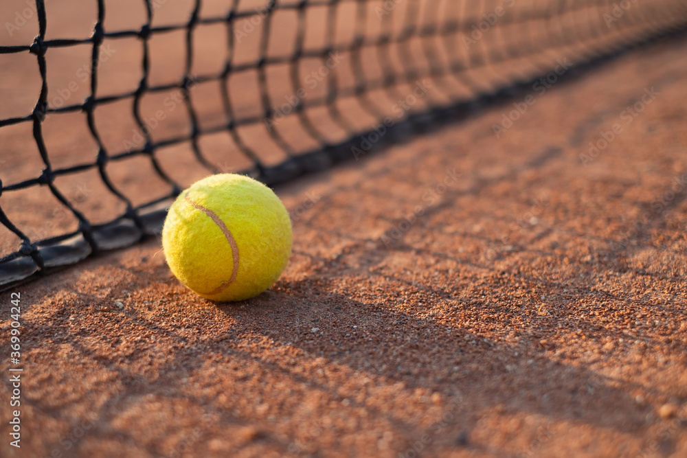 Tennis ball on the court. Sports equipment for active lifestyle. Ball and court as a background.