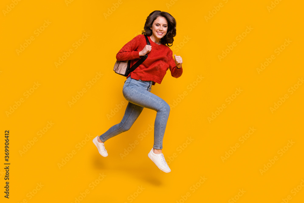 Full length body size view of her she nice attractive lovely cheerful cheery wavy-haired girl jumping running university study isolated on bright vivid shine vibrant yellow color background