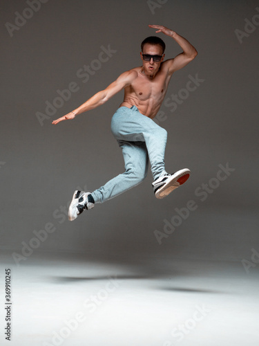 Cool young guy breakdancer jump dancing hip-hop. Dance school poster. Break dance lessons