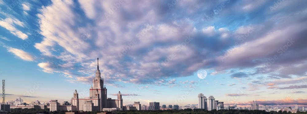 Fototapeta premium Aerial view of dramatic cloudy sky over main building of old university in sunset Moscow