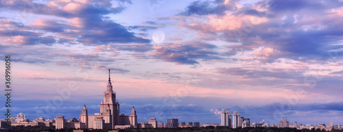 Aerial view of dramatic cloudy sky over main building of old university in sunset Moscow
