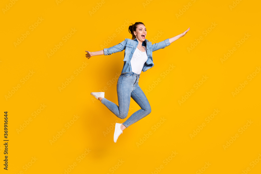 Full length body size view of her she attractive lovely slim careless cheerful cheery girl jumping having fun enjoying weekend vacation isolated bright vivid shine vibrant yellow color background