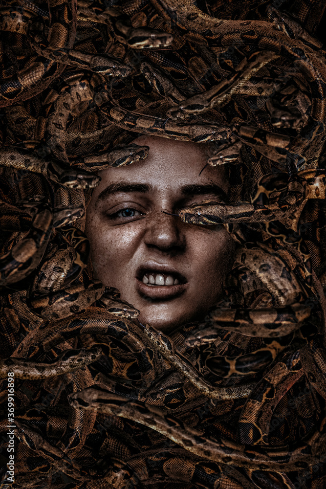 Beautiful man portrait with snakes