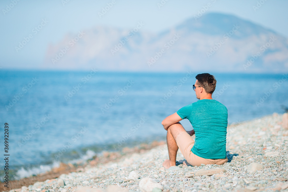 Young man on the white beach on vacation Young man on the white beach on vacation