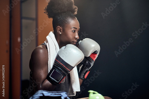 A young female boxer focused on the match photo