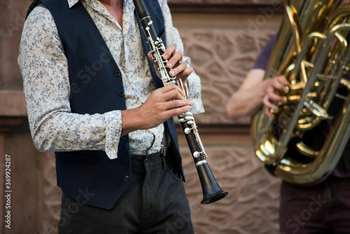 Fototapeta Closeup of musician playing with a clarinet in the street