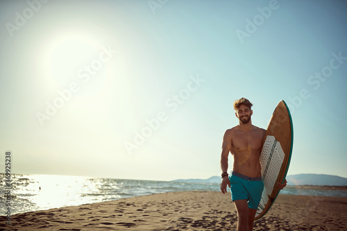 Sexy surfer posing on the beach