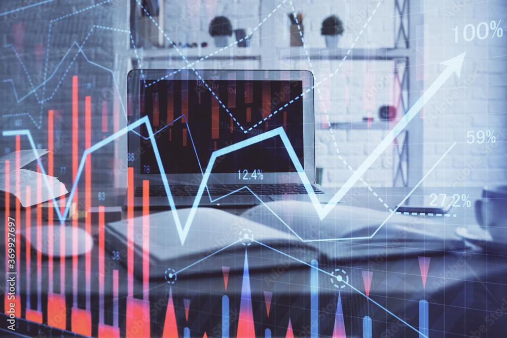 Stock market chart hologram drawn on personal computer background. Multi exposure. Concept of investment. Stock market chart hologram drawn on personal computer background. Multi exposure. Concept of investment.