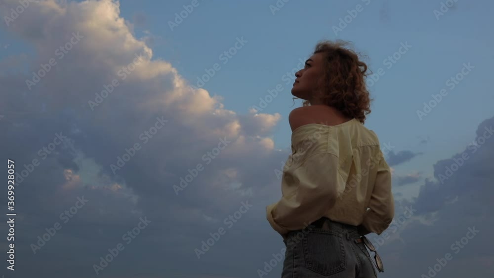 Woman looking clouds and weather on the sky Woman looking clouds and weather on the sky