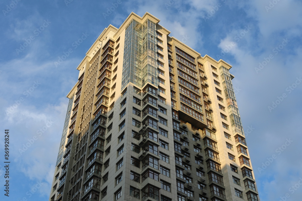 Fototapeta premium Scenic view of contemporary residential houses on a cloudy day. True modern cityscape of the Ukrainian capital. Design of contemporary build in big city. Real urban style of residential building.