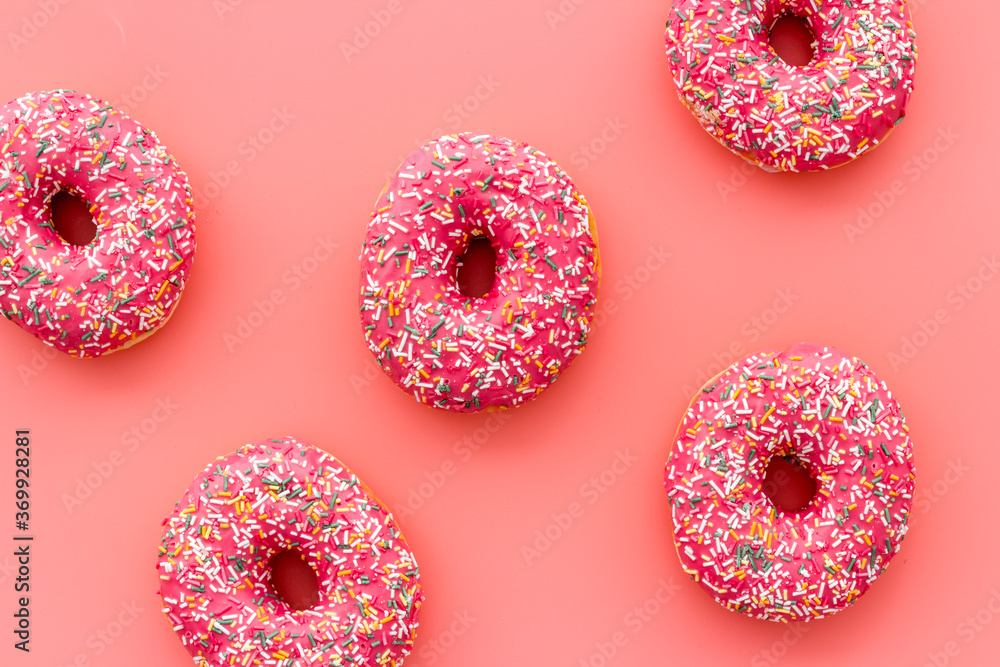 Donuts flat lay pattern on pink background, top view Donuts flat lay pattern on pink background, top view