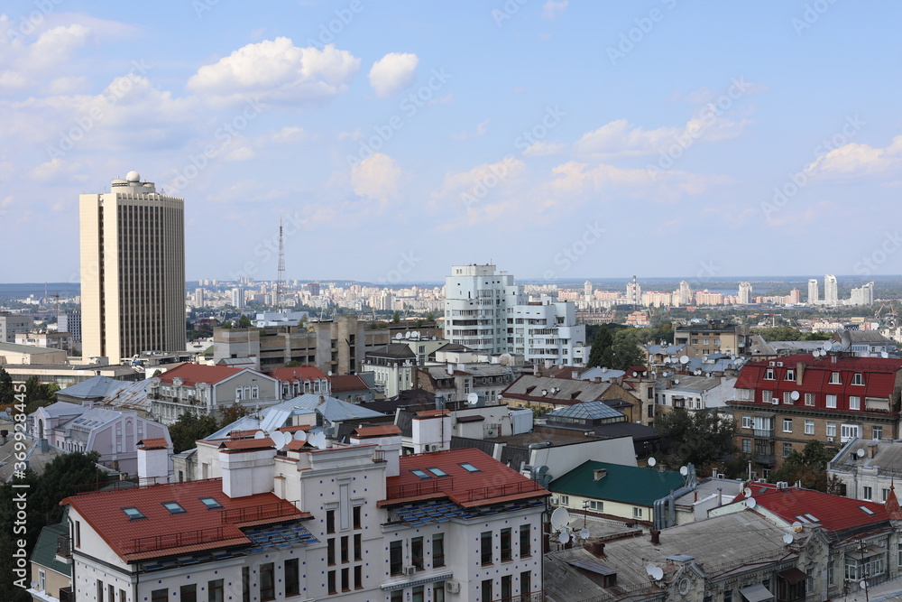 Obraz premium Scenic panoramic view of residential houses on a cloudy day. True modern cityscape of Ukrainian capital. Design of contemporary build in big city. Real urban style of residential building.