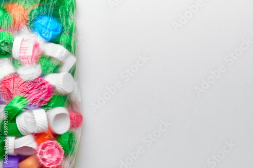 Polyethylene garbage bag with plastic lids of different colors and copy space