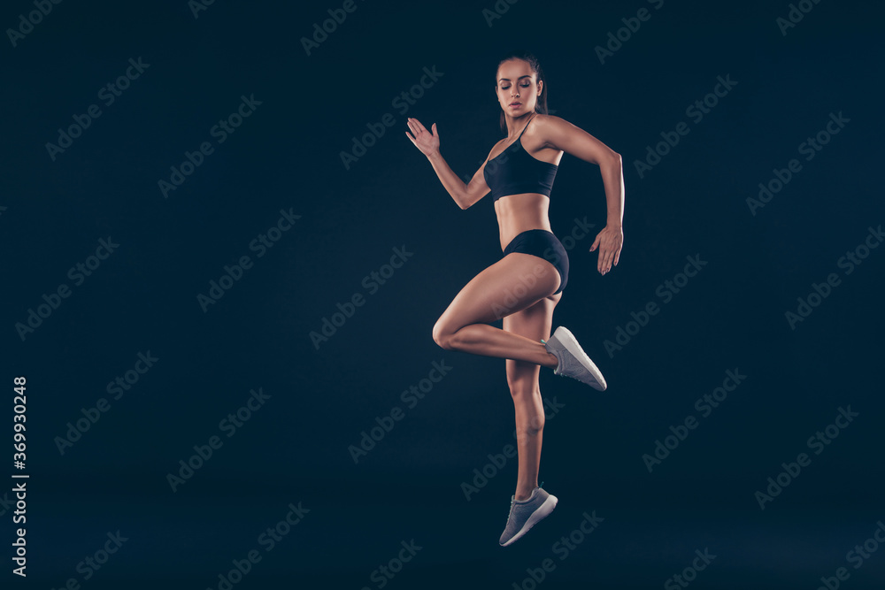 Full size profile photo short sport suit lady practicing warm up before sprint run jogging isolated black background