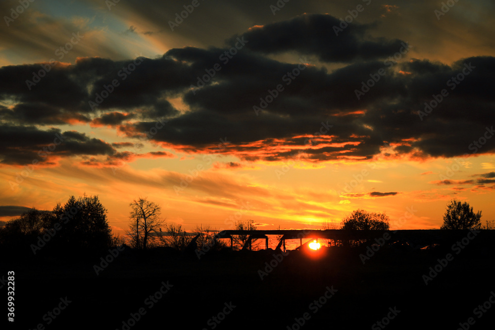 beautiful orange sunset with grey clouds in autumn beautiful orange sunset with grey clouds in autumn