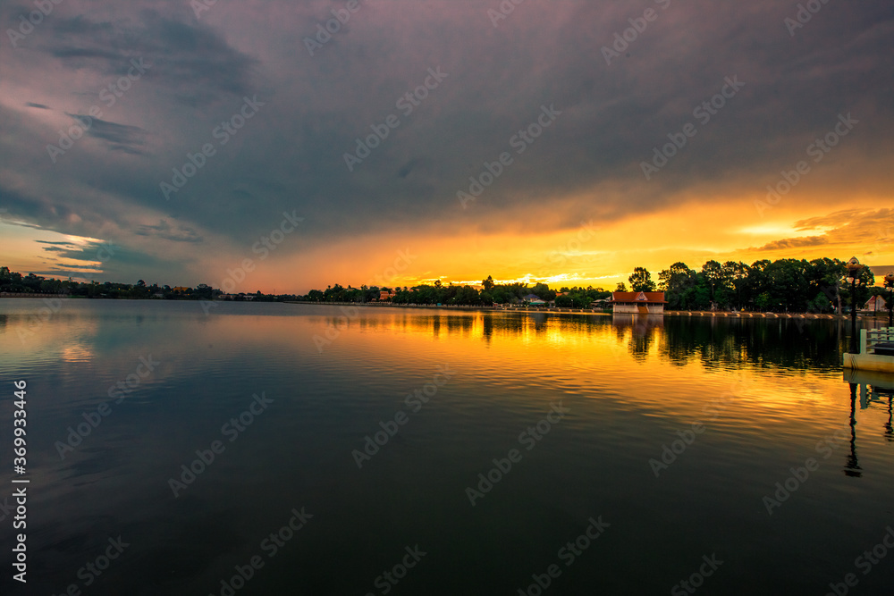 The blurry abstract background of the morning sky by the reservoir and there is a walkway to watch nature for exercise or rest while traveling The blurry abstract background of the morning sky by the reservoir and there is a walkway to watch nature for exercise or rest while traveling