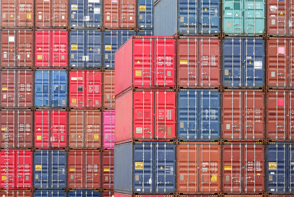 Fototapeta premium Four rows of vertical containers of different colors in the port