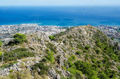 View from Calamorro mountain on mountains, hiking footpath, Mediterranean sea and Benalmadena town. Costa del Sol, province of malaga, Andalusia, Spain. photo