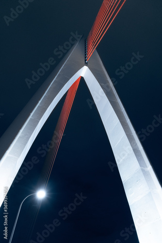 Architectural features of a bridge at night with a single street light