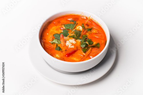 Red Thai style curry soup on a white background