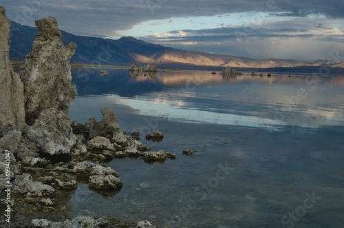 Landscape Mono lake with heavy clouds-partial blue sky tufa formation with distant range range and usual reflection in the adding much beauty and interst/