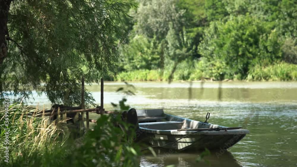 Peaceful view of desolated old boat docking on side of slow river. Peaceful view of desolated old boat docking on side of slow river.