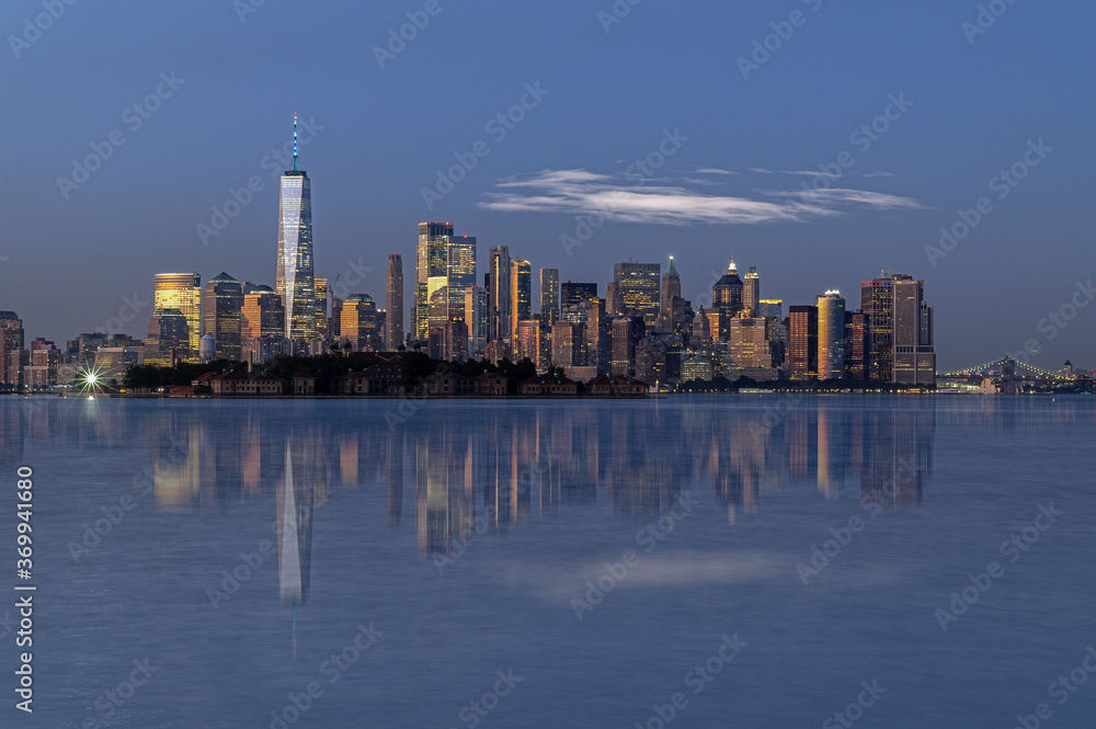 Reflections of New York city skyline at sunset
