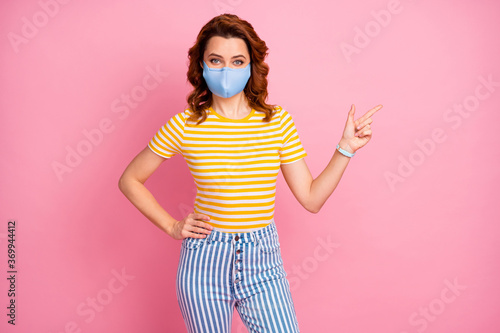 Portrait of her she nice attractive healthy wavy-haired girl wearing safety textile blue mask demonstrating copy space stop influenza vaccine contamination isolated pink pastel color background