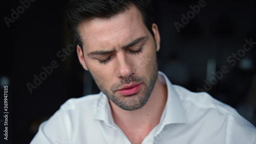 focused businessman looking down. Male worker thinking about business project