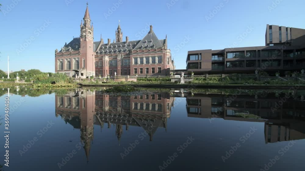 Peace Palace, one of the most visited monument in The Hague, reflected on the calm water of the rose garden and its pond, Netherlands Peace Palace, one of the most visited monument in The Hague, reflected on the calm water of the rose garden and its pond, Netherlands