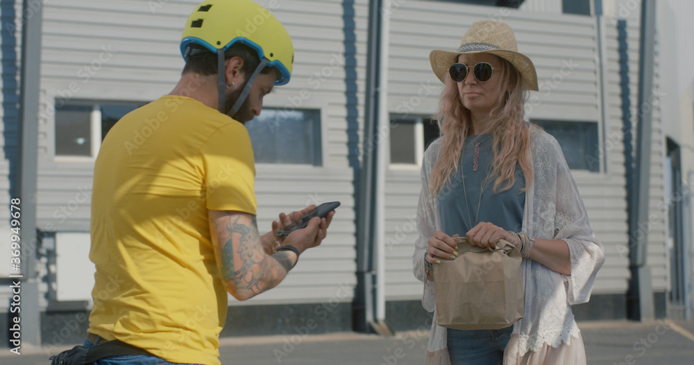 Bicycle messenger delivers food to woman Bicycle messenger delivers food to woman