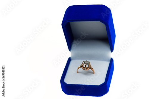 Isolated golden ring on blue gift box photo