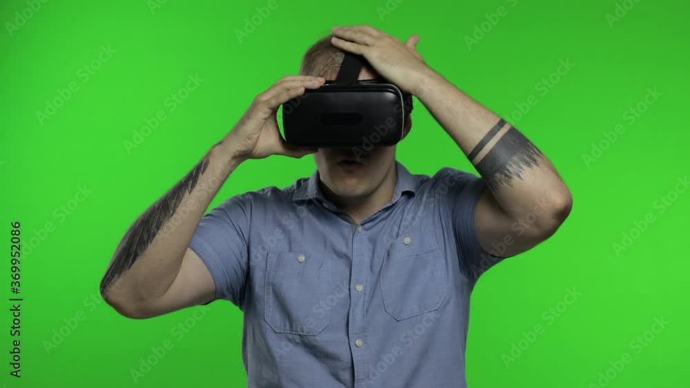 Man using VR headset helmet to play game. Watching virtual reality 3d 360 video. Chroma key