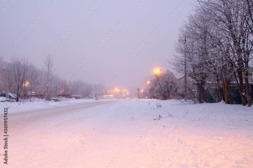 Winter day on the street of a small town. Frost on the trees. Fog. Winter day on the street of a small town. Frost on the trees. Fog.