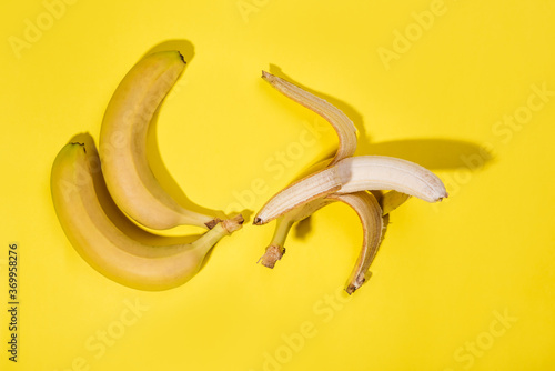 Fresh ripe bananas on the yellow background, close up