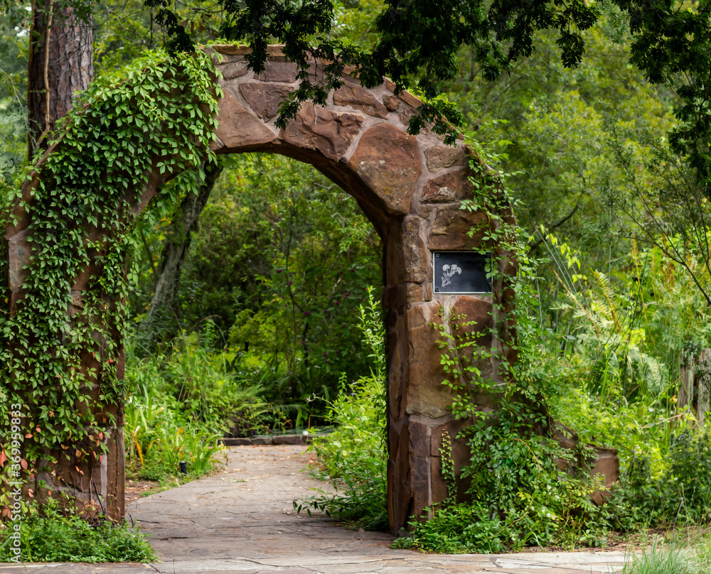 A stone arch leading into a secret garden in Spring, TX.