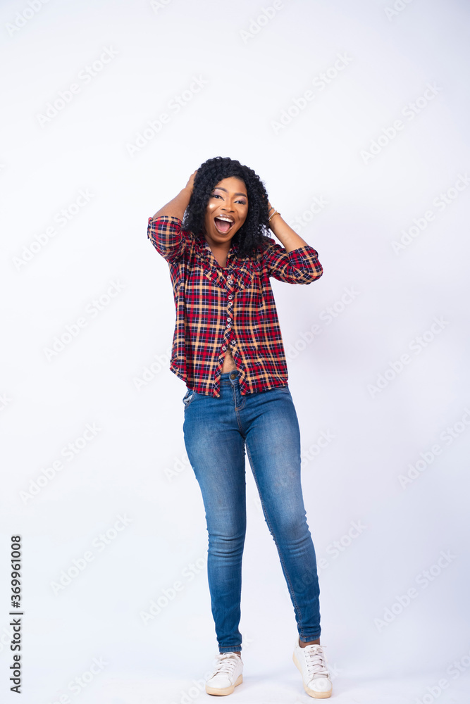 ecstatic young black girl holding her head with a look of amazement ecstatic young black girl holding her head with a look of amazement