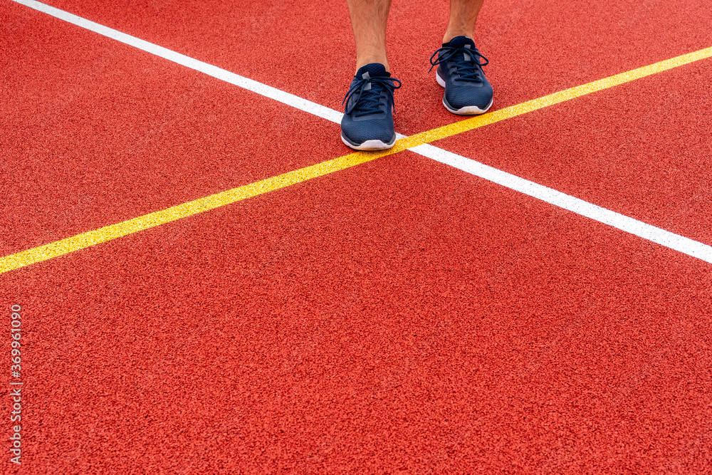 Athlete standing on a red color game court Athlete standing on a red color game court