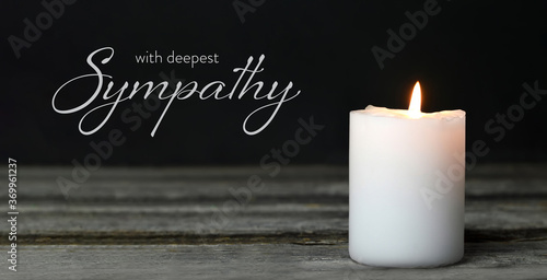 Fotografía Sympathy card. Memorial candle on wooden background
