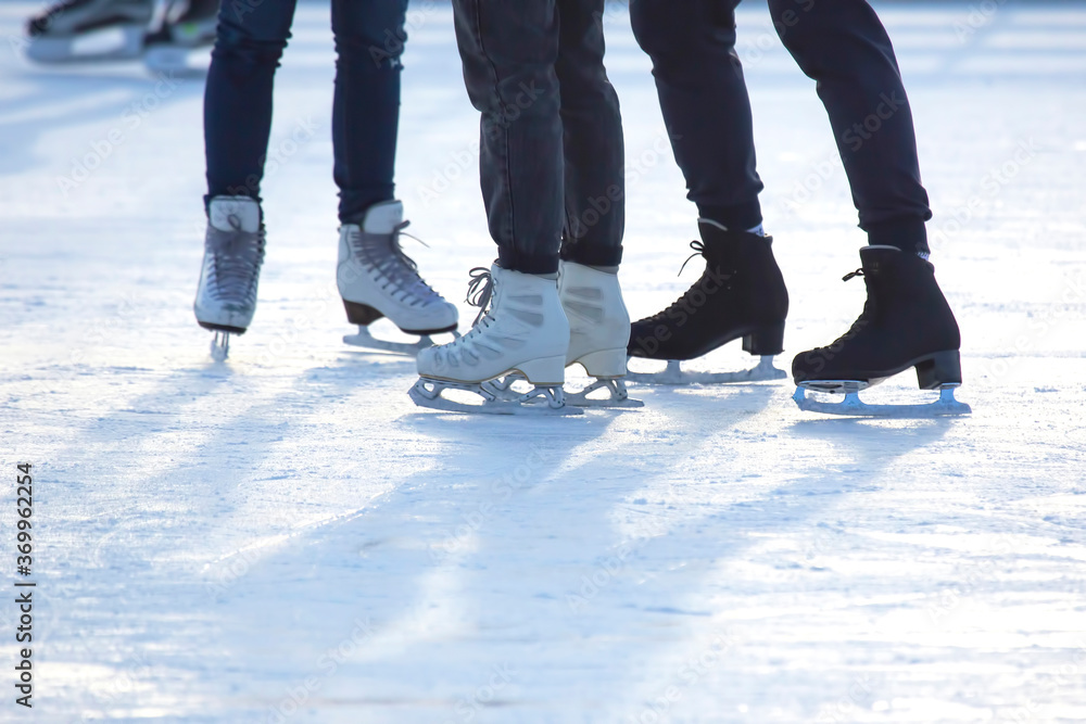 different people are actively skating on an ice rink. hobbies and leisure. winter sports different people are actively skating on an ice rink. hobbies and leisure. winter sports