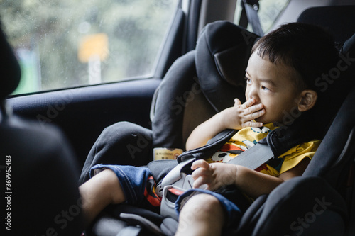 1 Year Old Adorable Asian Boy Alone Looking Around From Car Seat in the Car photo