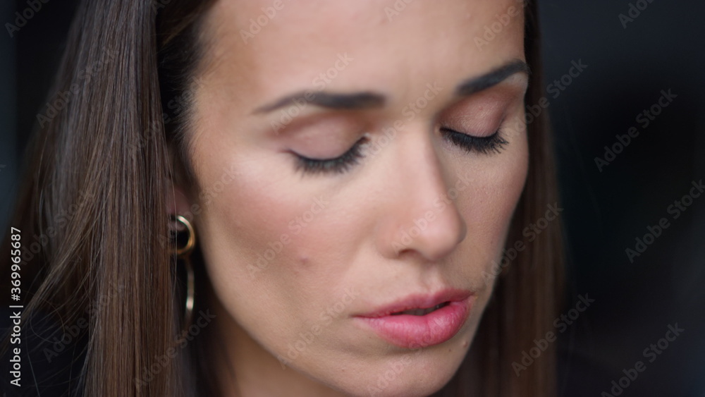 Pensive businesswoman focusing on work. Female worker looking down Pensive businesswoman focusing on work. Female worker looking down