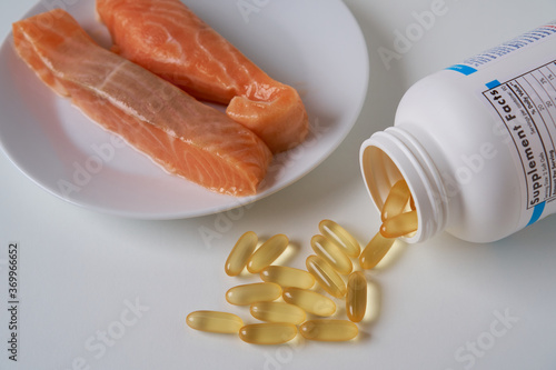 Fish oil capsules and salmon fillet slice    