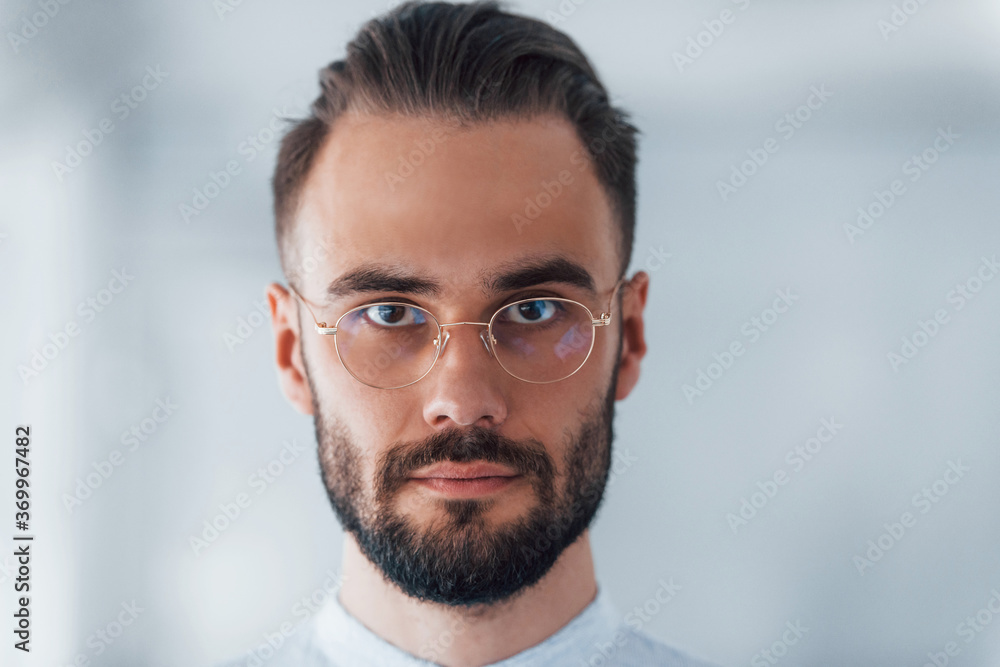 Portrait of young handsome man in formal clothes indoors in the office at daytime Portrait of young handsome man in formal clothes indoors in the office at daytime