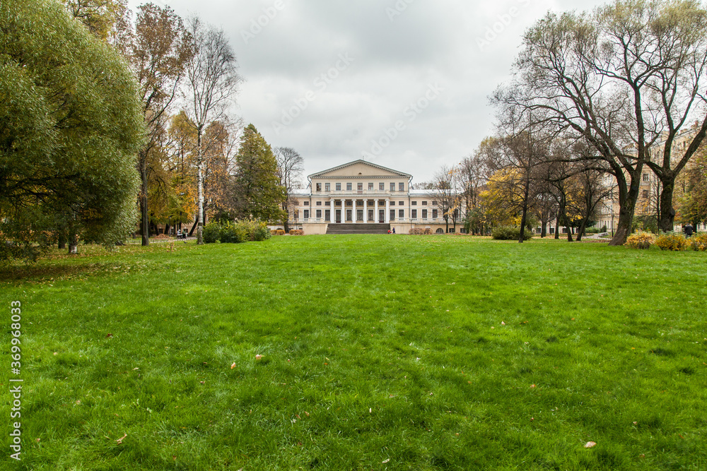 Green lawn in front of old aristocratic mansion