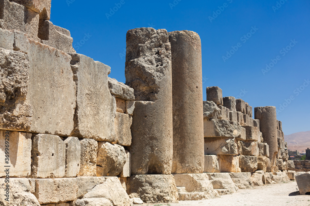 Baalbek temple complex in Lebanon. Ancient massive Roman ruins. View of the columns and old stone walls on the background of clear blue sky