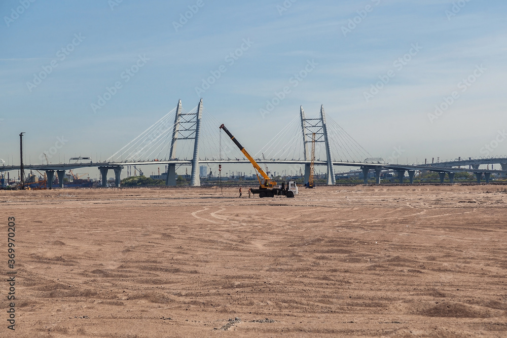 Truck crane on pusyoe near the cable-stayed bridge Truck crane on pusyoe near the cable-stayed bridge