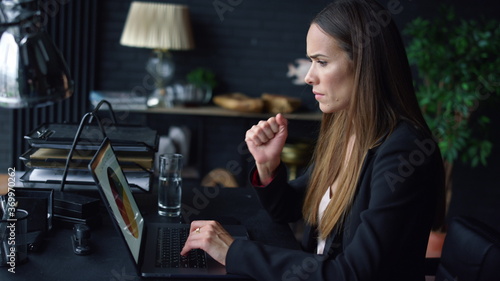 Businesswoman analyzing graphics on screen. Woman typing on laptop keyboard