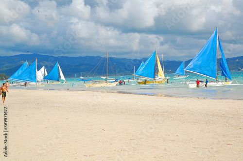 Blue and white beach sail boats at Boracay Island in Aklan, Philippines